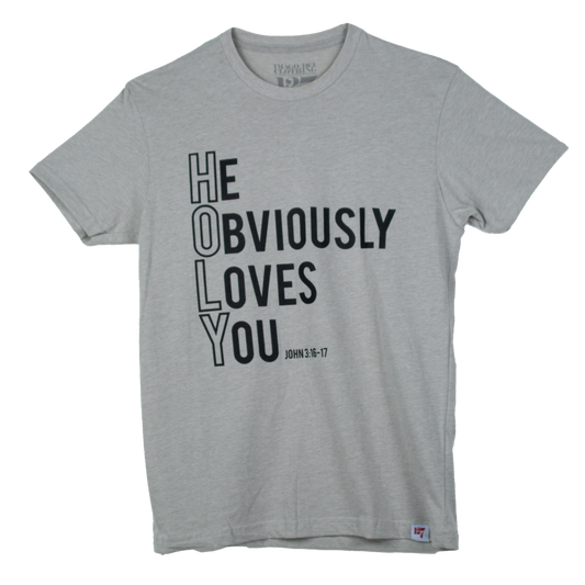 Beige t-shirt with the words He Obviously Loves You written downwards to show the word HOLY. The verse points to John 3:16-17