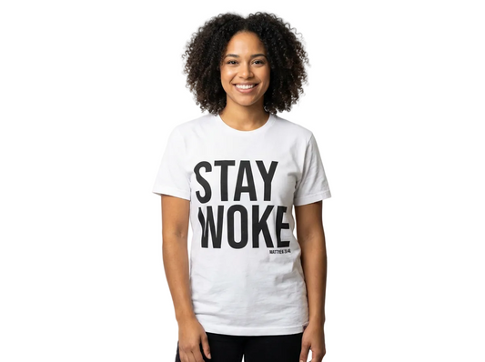 Person wearing a white t-shirt with 'STAY WOKE' text on a plain background