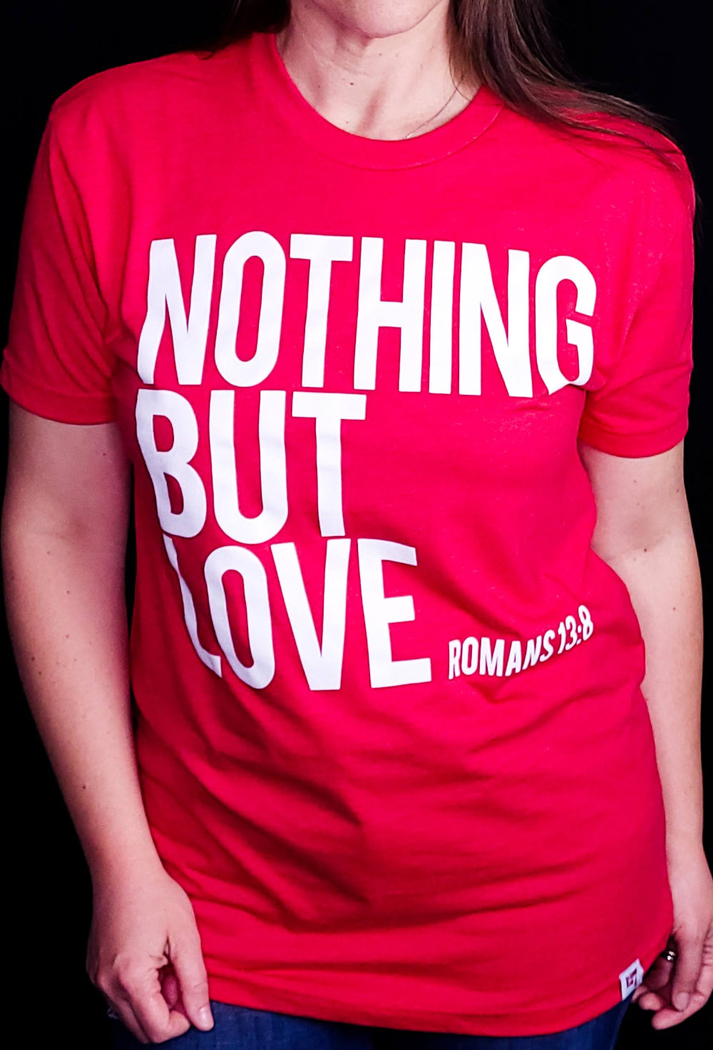 Red shirt with the words Nothing But Love on the front in white writing.