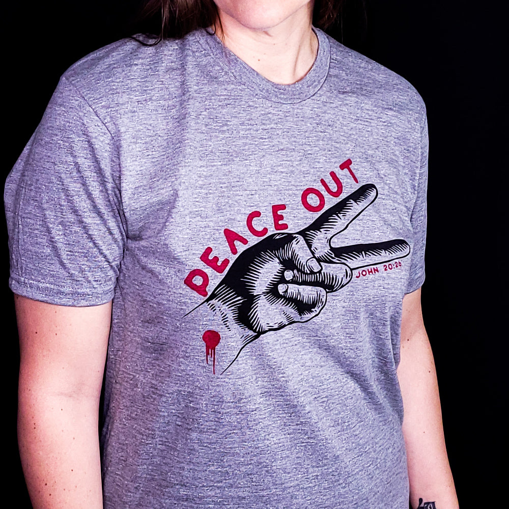 Gray shirt with the words Peace Out over two fingers making the peace sign. Referencing the verse John 20:26