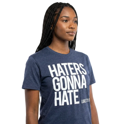 Person wearing a blue t-shirt with 'HATERS GONNA HATE' text on a white background