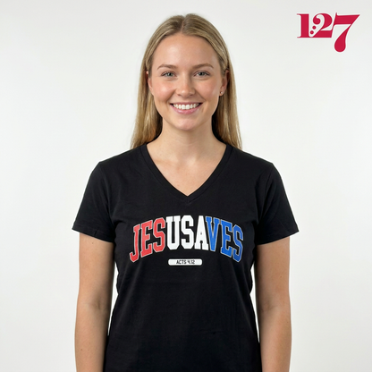 white woman wearing a black v-neck t-shirt that says "Jesusaves" across the front of the shirt in red white and blue letters. 