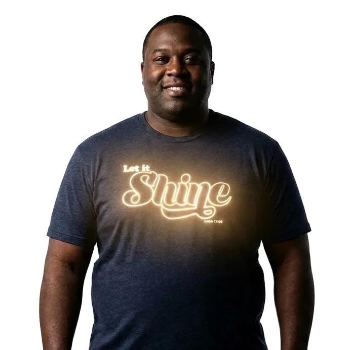 Man wearing a dark blue t-shirt with 'Let It Shine' text on a white background
