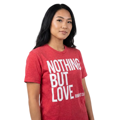 Person wearing a red t-shirt with 'NOTHING BUT LOVE' text on a white background