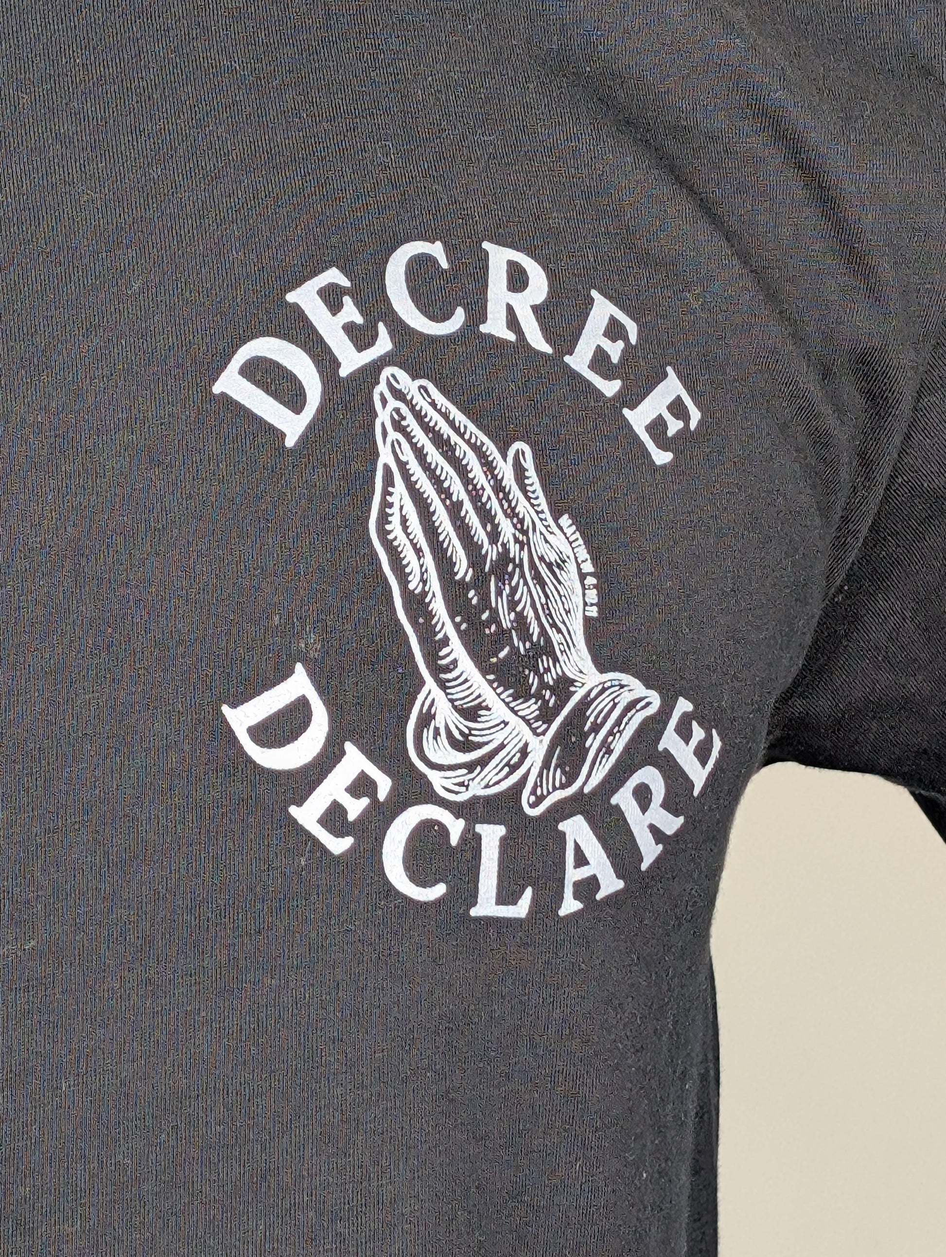 Black t-shirt with 'Decree Declare' graphic on a plain background