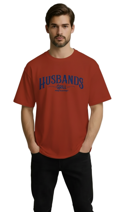 Man wearing a red t-shirt with 'HUSBANDS' printed on it against a gray background