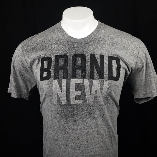 Gray t-shirt with the word brand  across the front that reveals the word New when it gets wet. 