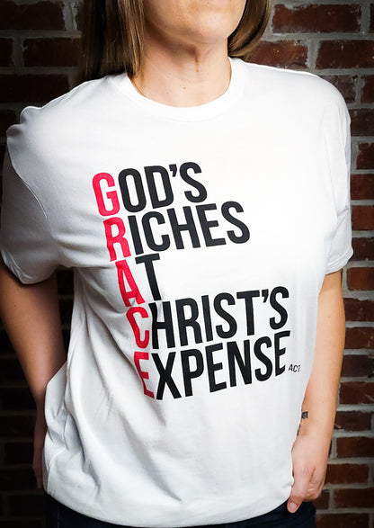 White Short sleeved t-shirt with the words God's Riches At Christ's Expense to spell out the word GRACE. Verse referenced is Acts 20:24