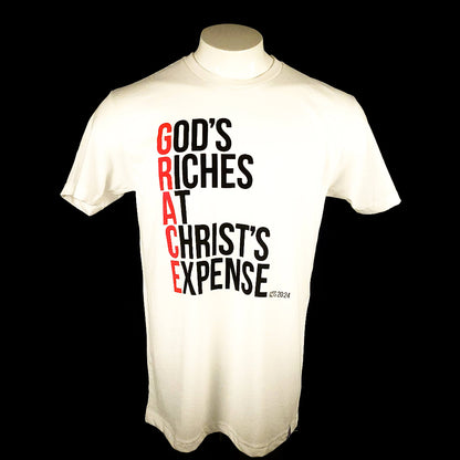 White Short sleeved t-shirt with the words God's Riches At Christ's Expense to spell out the word GRACE. Verse referenced is Acts 20:24