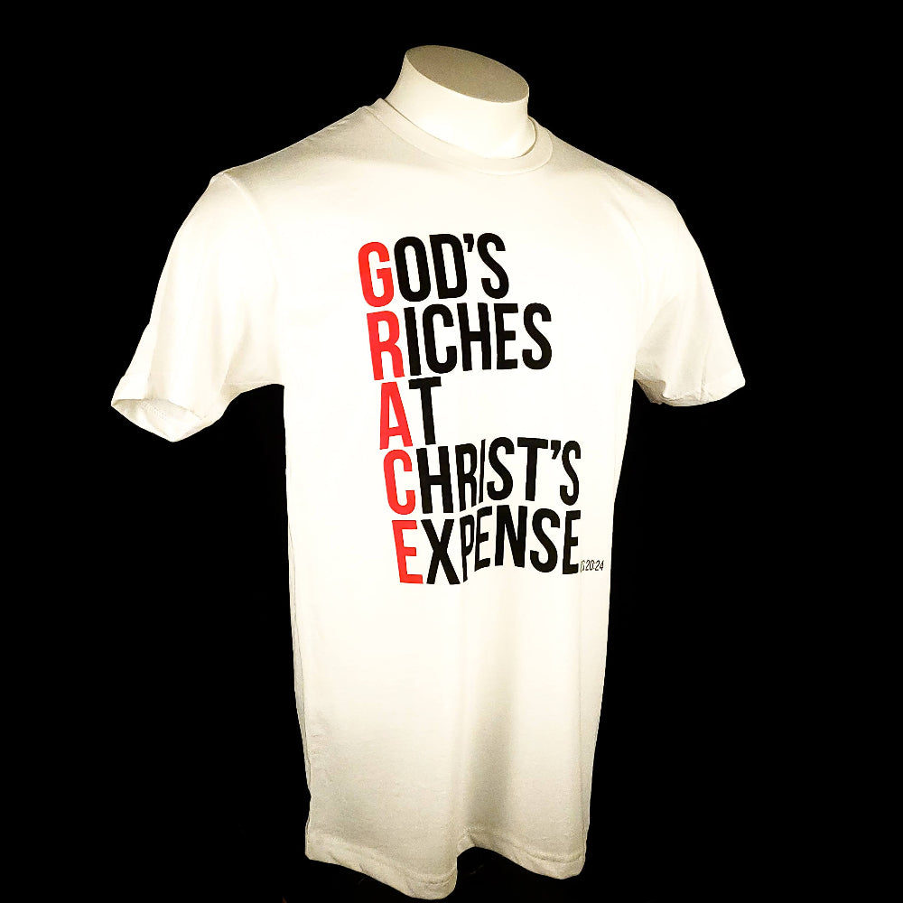 White Short sleeved t-shirt with the words God's Riches At Christ's Expense to spell out the word GRACE. Verse referenced is Acts 20:24