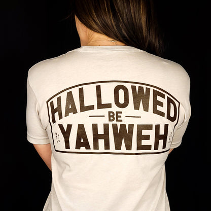 Sand Colored t-shirt with front design the says Hallowed Be Yahweh, full back design says Hallowed be Yahweh.
