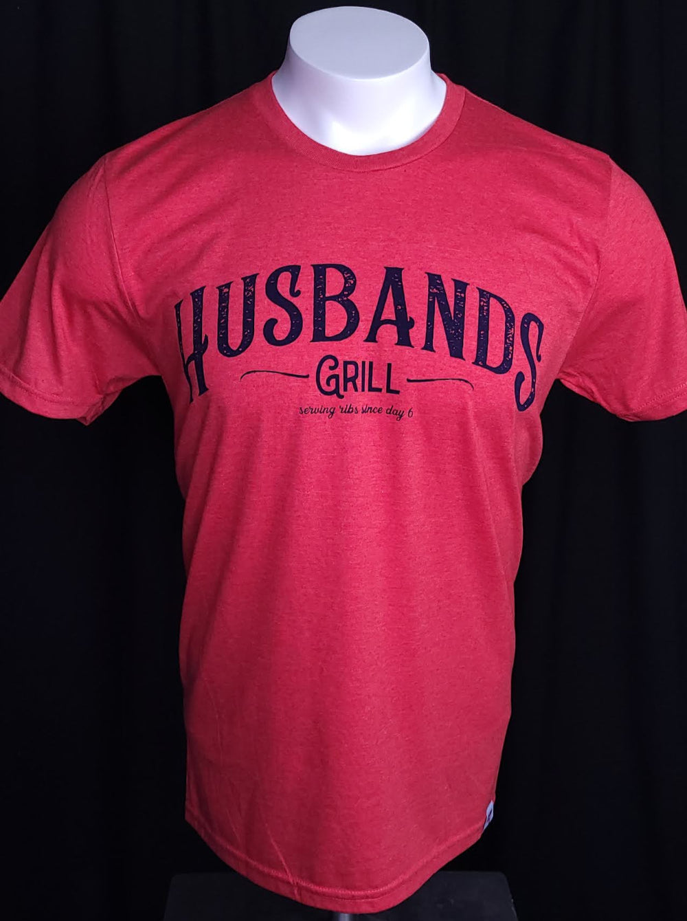 Red shirt that reads Husbands Grill across the chest. 